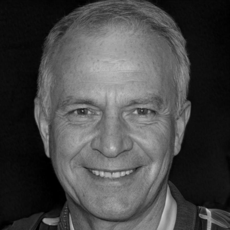 Harlan McKenzie, financial workshop facilitator, smiling in professional attire